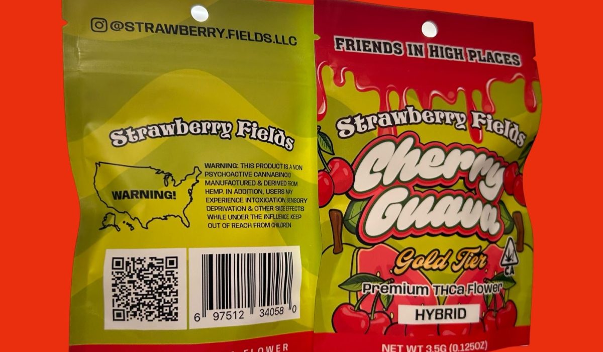 A package of Strawberry Fields cherry guava gold tier premium THCa flower displayed on a bright red background.
