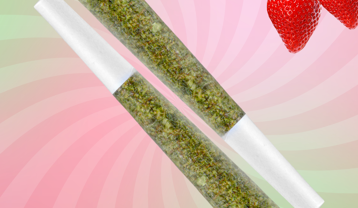 A vibrant strawberry and two cannabis prerolls displayed against a soft pink and green spiral background